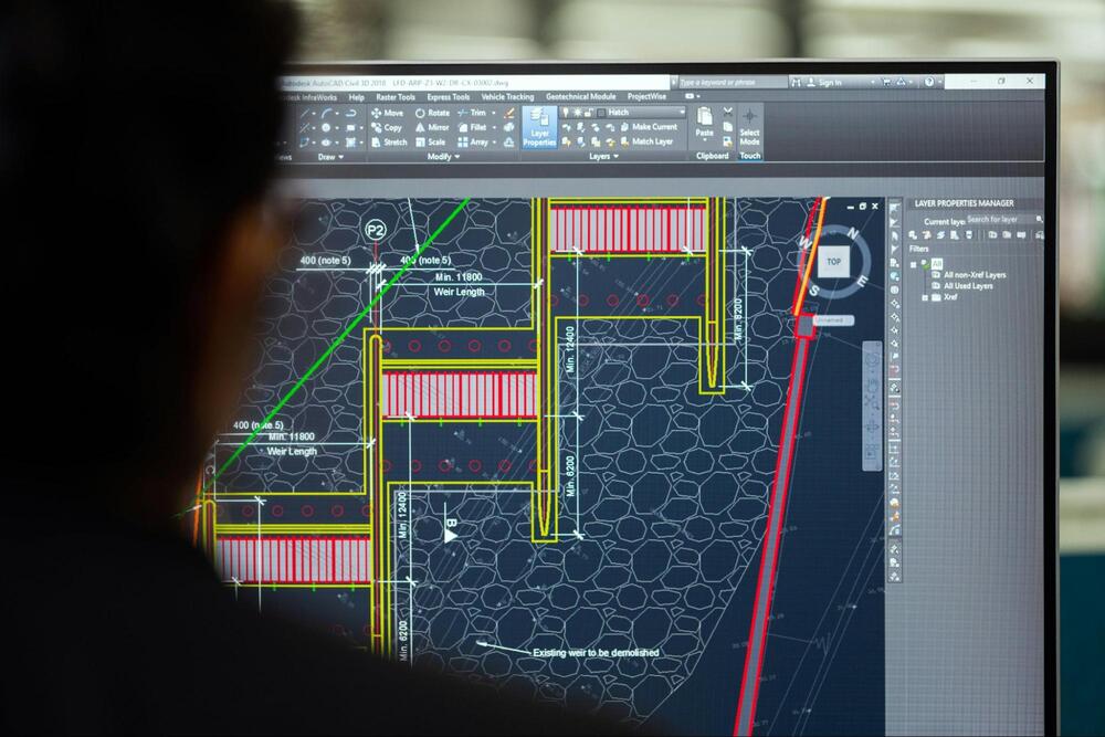 An engineer uses CAD software to design a DAM structure.