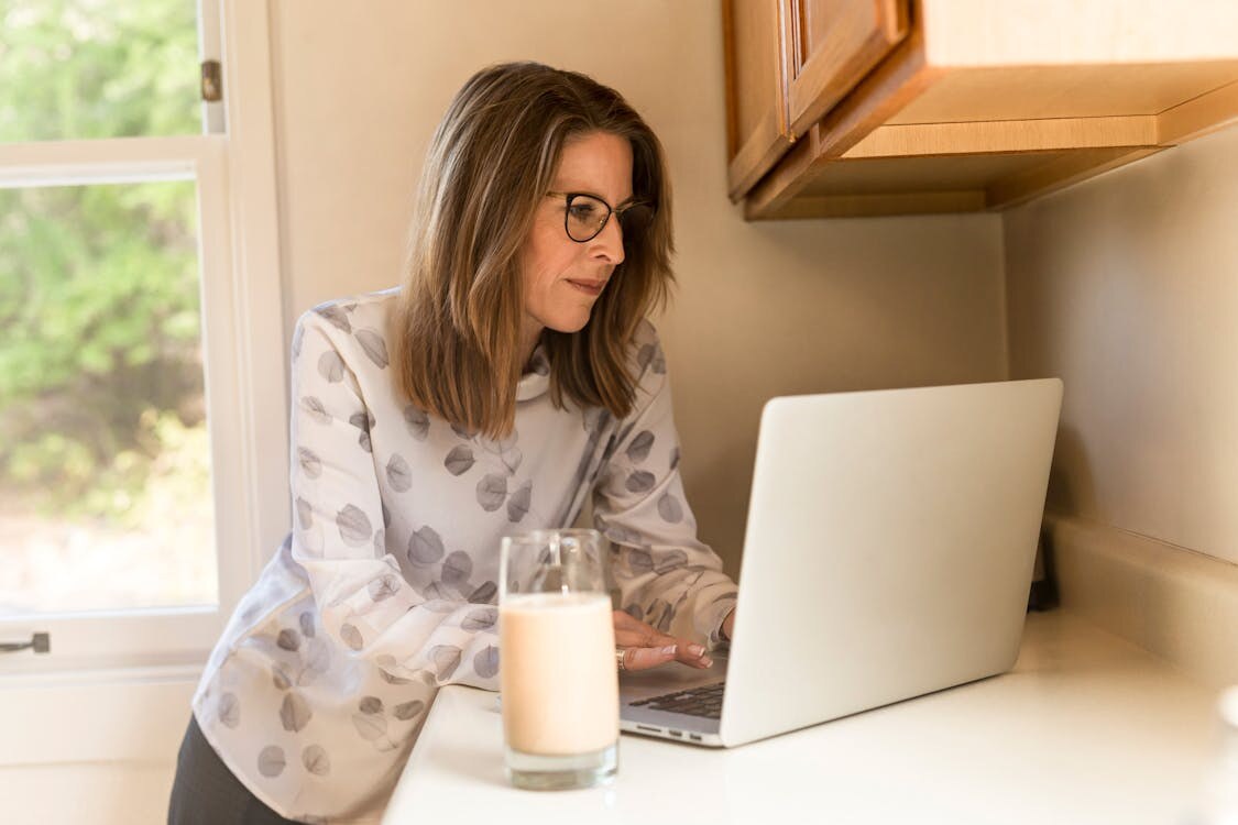 A person using a laptop to find out how to find the OS version on Windows